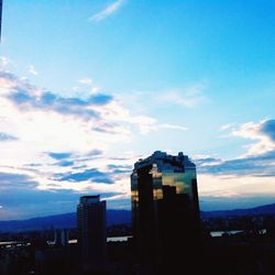 View of cityscape against blue sky