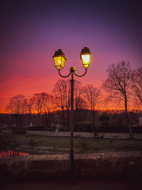 Low angle view of street light against sky during sunset