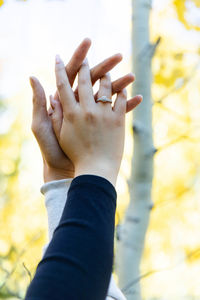 Engaged couple holding hands