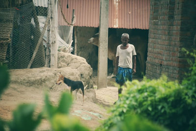 Rear view of woman walking on field