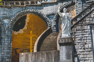 Low angle view of statue against building