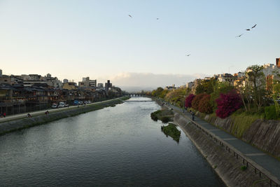 View of river and buildings against sky