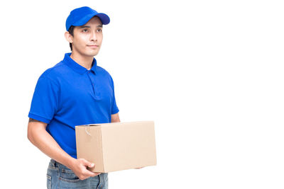 Salesman with cardboard box standing against white background