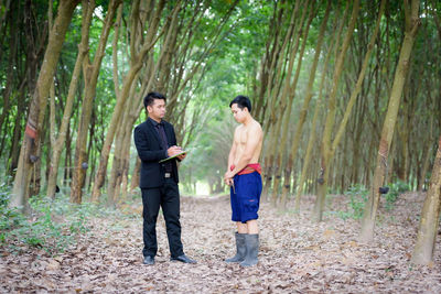 Full length of a young man in forest