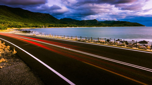 Panoramic view of road by mountain against sky