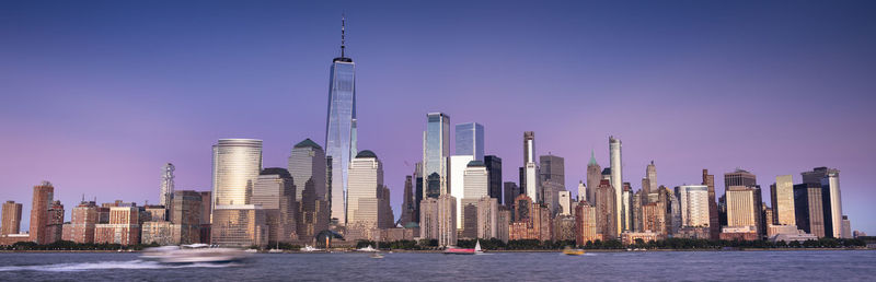 Panoramic view of buildings in city against clear sky