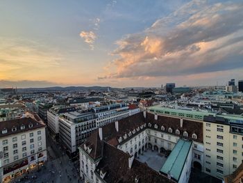 High angle shot of townscape against sky at sunset