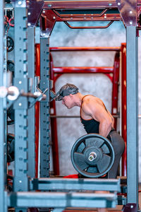 Midsection of man exercising in gym