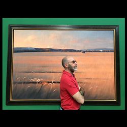 Man looking away while sitting on window