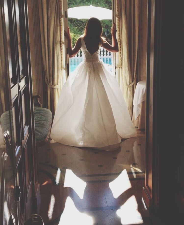 REAR VIEW OF WOMAN SITTING IN CORRIDOR