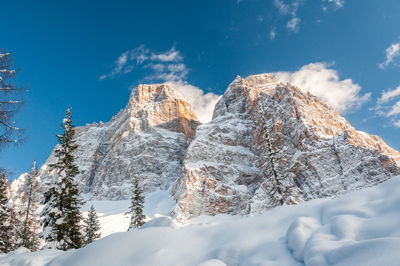 Low angle view of snowcapped mountain against sky