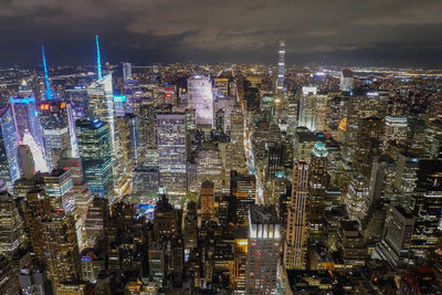 Aerial view of city lit up at night