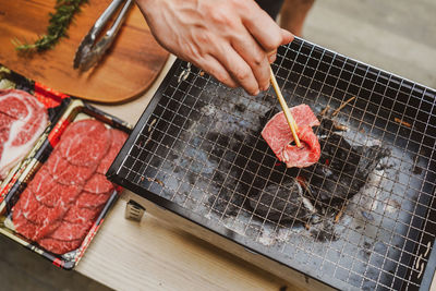 Cropped hand of man preparing food