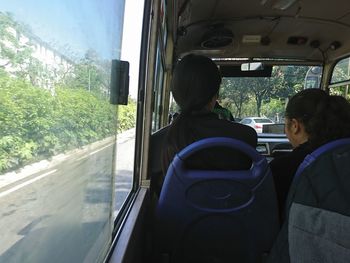 Rear view of woman sitting in car