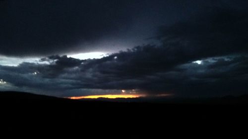 Scenic view of silhouette landscape against sky at night