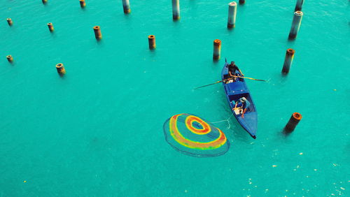 Aerial view of men fishing in sea