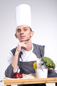 Portrait of young man against white background