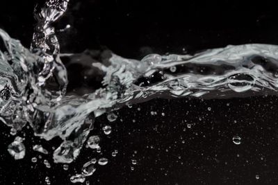 Close-up of water splashing against black background