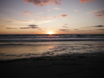 Scenic view of beach against sky during sunset