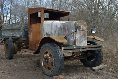 Abandoned vintage car on field