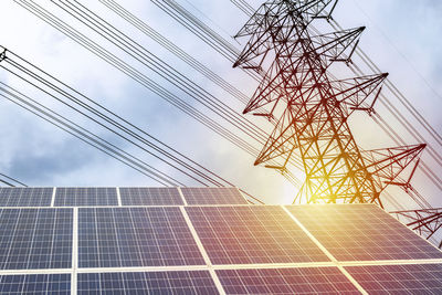 Low angle view of electricity pylon against sky