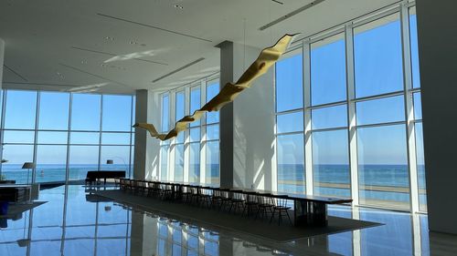 View of swimming pool against sky seen through window