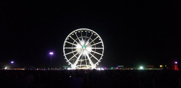 Illuminated ferris wheel at night