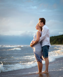 Side view of couple on beach