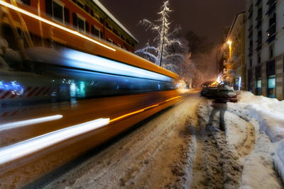 Blurred motion of bus in city at night