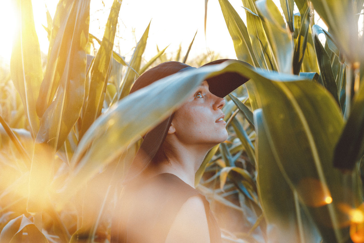 one person, growth, nature, young adult, outdoors, young women, day, leisure activity, summer, real people, sunlight, plant, close-up, beauty in nature, people