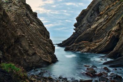 Scenic view of sea and mountains against sky