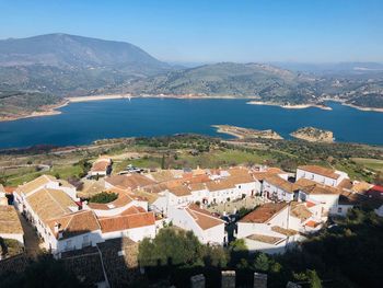 High angle view of townscape by sea against sky