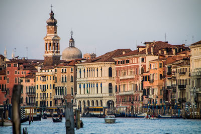 Boats in canal with buildings in background