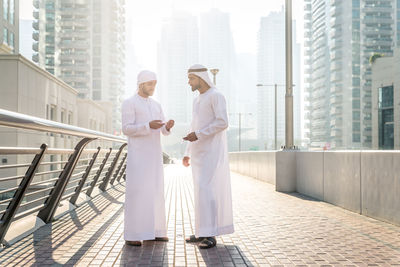 People standing by buildings in city