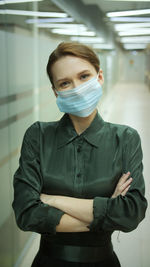 Portrait of woman wearing mask at office