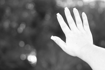 Close-up of woman hand against blurred background