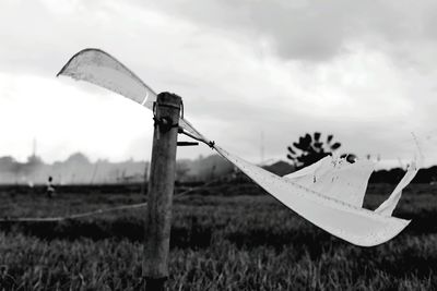 Close-up of boat on field against sky