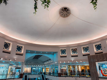 Low angle view of illuminated pendant lights hanging on ceiling in building