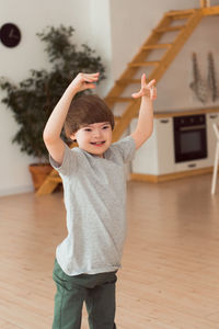 Child down syndrome playing or dancing at home