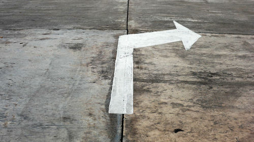 High angle view of arrow sign on road