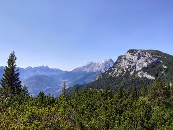 Scenic view of mountains against clear blue sky