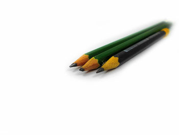 High angle view of colored pencils on white background