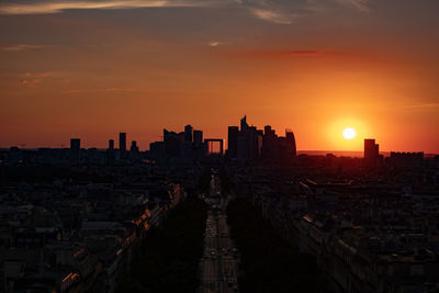 Buildings in city during sunset