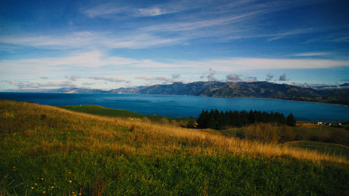 Scenic view of field and mountains against sky