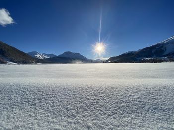 Scenic view of snowcapped mountains against blue sky