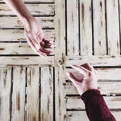 Close-up of hand holding wooden plank