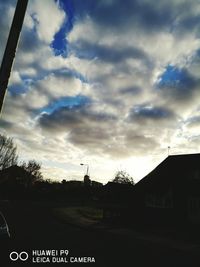 Low angle view of silhouette building against sky