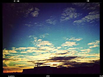 High section of built structure against sky at sunset