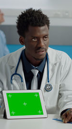 Portrait of doctor using digital tablet