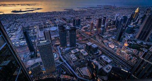 High angle view of buildings in city at dusk